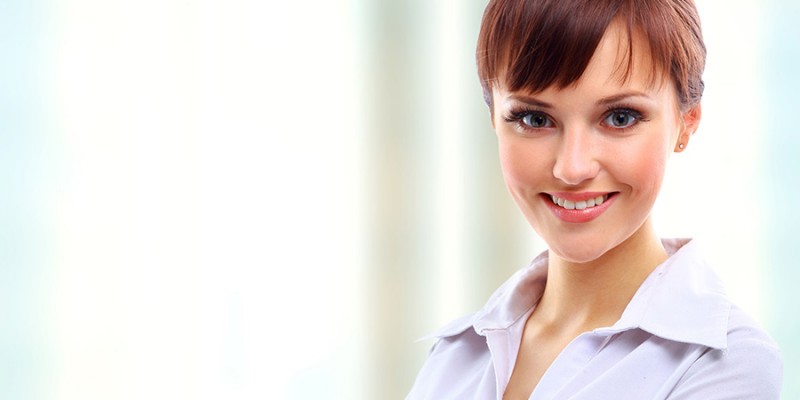 Positive business woman smiling over white background